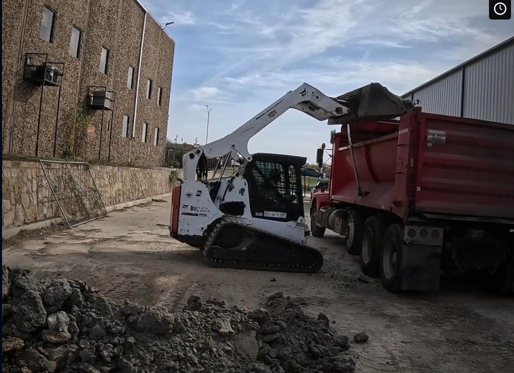Skid steer and dump truck